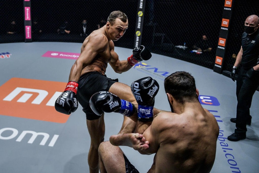 Roman Kryklia throws a head kick in the ONE Championship cage.