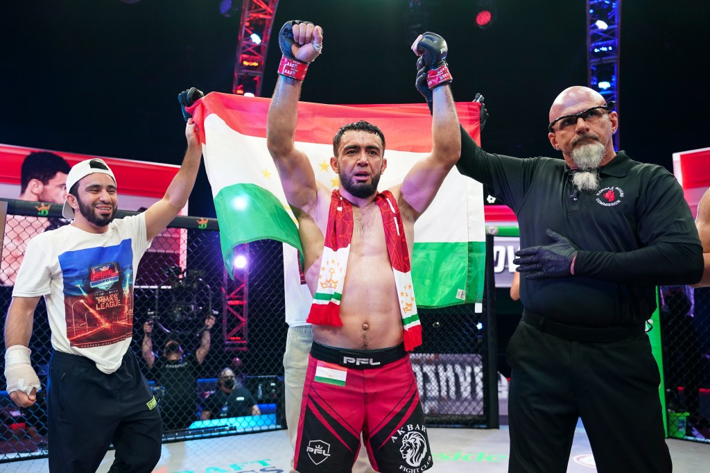 Loik Radzhabov gets his arm raised by a referee.