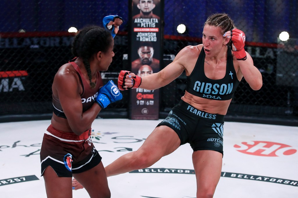 Julia Budd throws a leg kick at Dayana Silva.