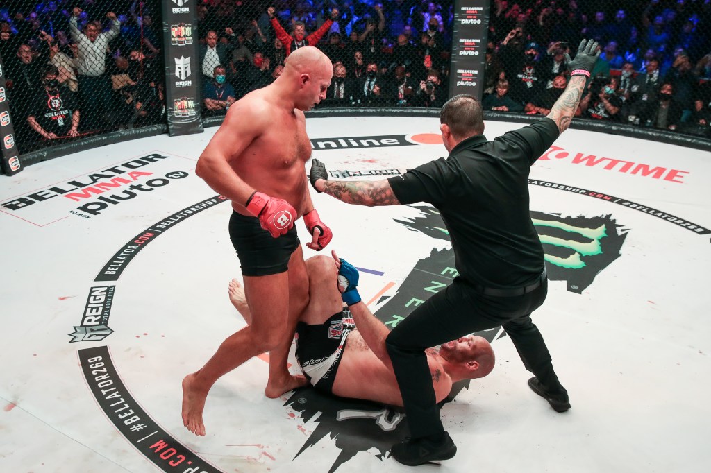 Fedor Emelianenko stands over Timothy Johnson while the referee waves off their MMA match.