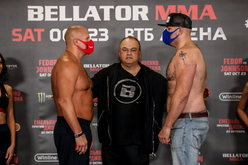 Fedor Emelianenko and Timothy Johnson face each other at a ceremonial weigh-in conference.