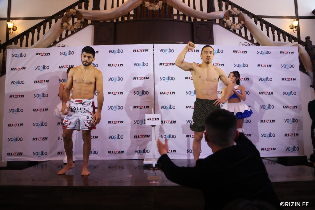 Roberto Satoshi Souza and Yusuke Yachi pose at RIZIN's ceremonial weigh-ins.