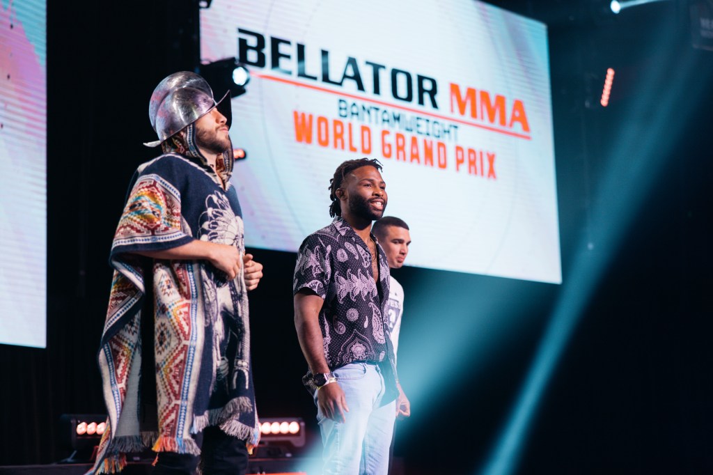 Juan Archuleta and Raufeon Stots stand on a stage while the words "Bellator MMA Bantamweight World Grand Prix" are on a screen behind them.