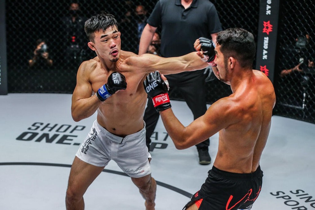 Christian Lee throws left hook to Ok Rae Yoon inside the ONE Championship cage.